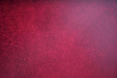Abstract festive background with selective focus. Bright particles on dark red Stock-Illustration