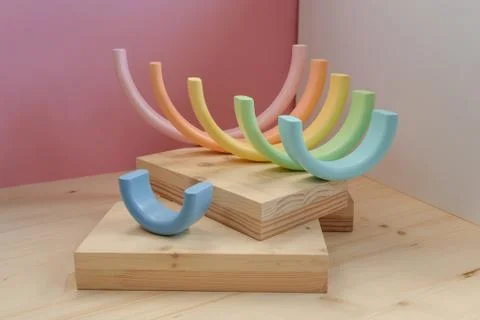 Abstract figures from elements of the children's designer wooden pastel rainbow Foto stock