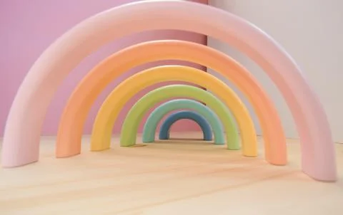 Abstract figures from elements of the children's designer wooden pastel rainbow Foto stock