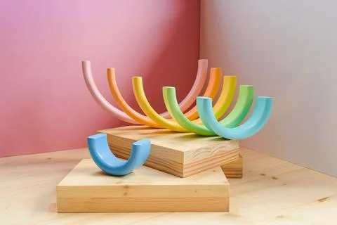 Abstract figures from elements of the children's designer wooden pastel rainbow Foto stock