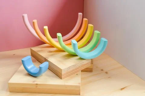 Abstract figures from elements of the children's designer wooden pastel rainbow Stock Photos