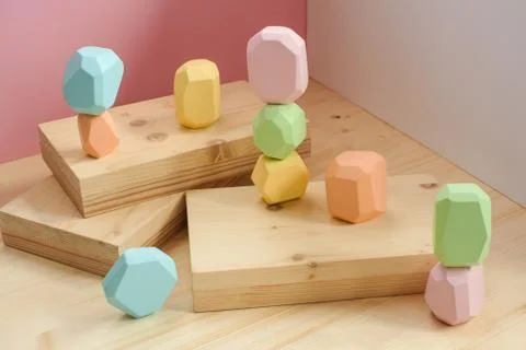Abstract figures from elements of wooden tumi ishi pastel colors on a wooden Foto stock
