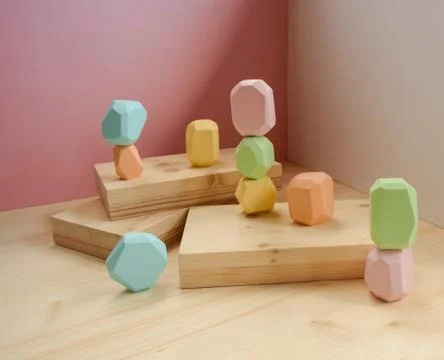 Abstract figures from elements of wooden tumi ishi pastel colors on a wooden Stock Photos