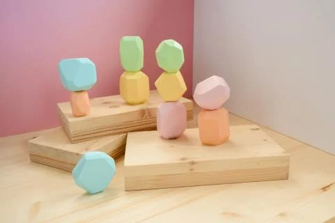 Abstract figures from elements of wooden tumi ishi pastel colors on a wooden Foto stock