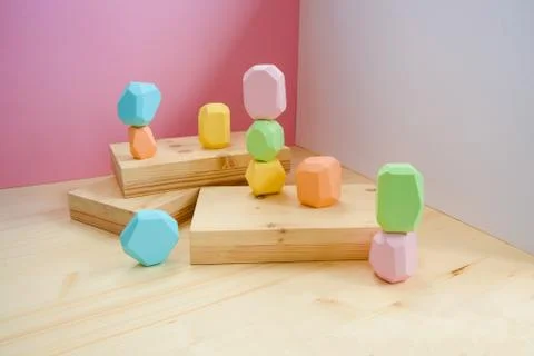 Abstract figures from elements of wooden tumi ishi pastel colors on a wooden Foto stock