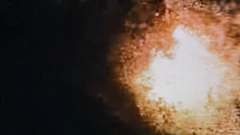 Abstract fire explosion pixels on dark screen Stock Photos