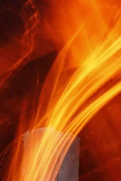 Abstract flame texture Abstract flame texture with old metal chimney at ni... Stockfoto's