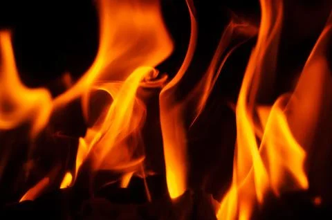 Abstract flames dancing against a dark background, fiery and vibrant Stock Photos