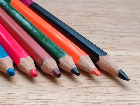 Abstract Flat Lay / Layout with Sharpened color pencils placed on a wood Stock Photos