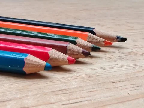 Abstract Flat Lay / Layout with Sharpened color pencils placed on a wood Stock Photos