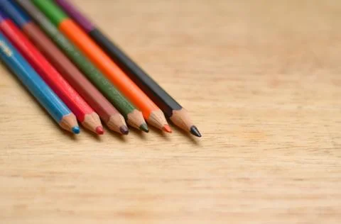 Abstract Flat Lay / Layout with Sharpened color pencils placed on a wood Stock Photos