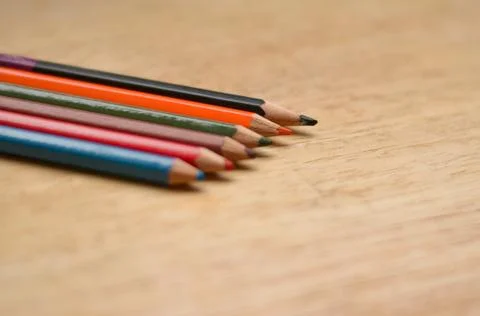 Abstract Flat Lay / Layout with Sharpened color pencils placed on wood Stock Photos