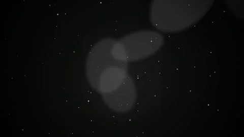 Abstract floating white bokeh light particles drifting slowly over a dark black Stock Footage 346218306