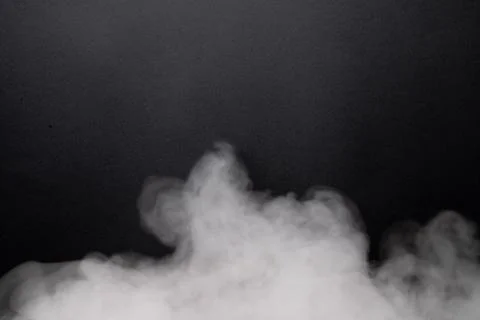 The abstract flow of smoke from a black background. Stock Photos