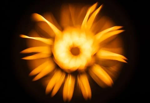An abstract flower pattern of a blurred tungsten lamp glowing in the dark Stock Photos