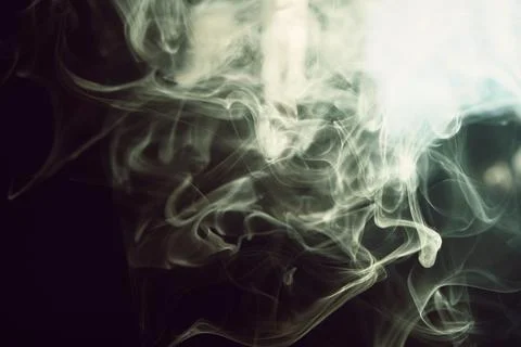Abstract flowing smoke waves creating dynamic patterns against a dark backg.. Stock Photos