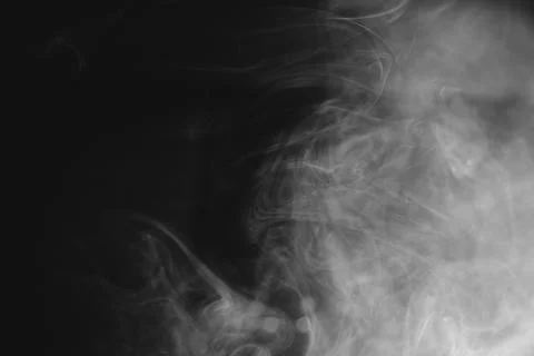 Abstract flowing white smoke patterns on a dark background for design and t.. Stock Photos