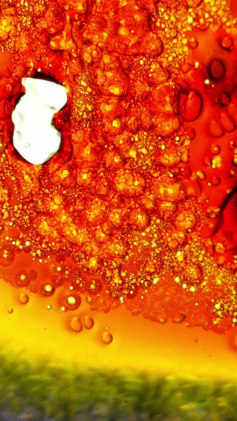 Abstract fluid motion with bubbles and droplets in red, orange, and yellow Stock Footage 344983891