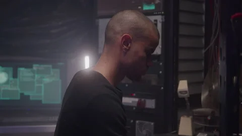 Abstract Focused Hacker with Shaved Head Works in High Tech Basement Stock Footage 208800856