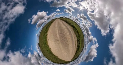 Abstract folding of the earth plane into tiny planet in blue sky with clouds. Stock Footage 182505617