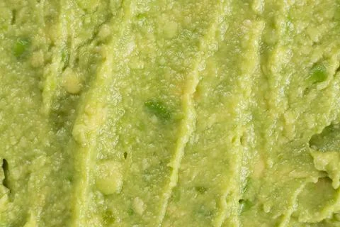 Abstract food background of fresh mashed avocado texture Stock Photos