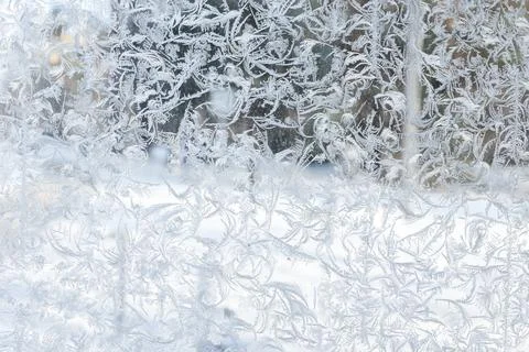 Abstract frost pattern covering window glass, background photo Stock Photos