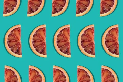 Abstract fruit summer background. seamless pattern of red orange slices on gr Stock Photos