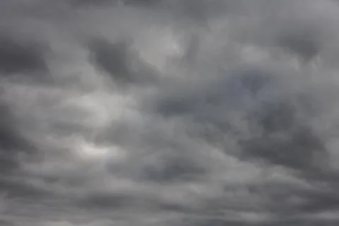 Abstract full-frame background of overcast sky with solid cover of grey clouds Stock Photos