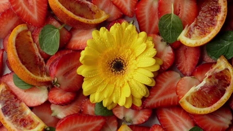 Abstract Fusion of Elements: Yellow Flower and Strawberry against a Vibrant Stock Footage 241333544