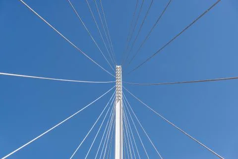 Abstract geometric architectural elements of a bridge against blue sky. Stock Photos