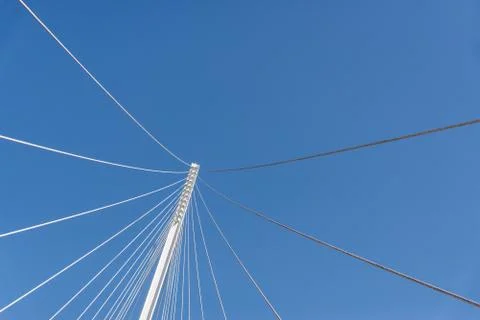 Abstract geometric architectural elements of a bridge against blue sky. Stock Photos