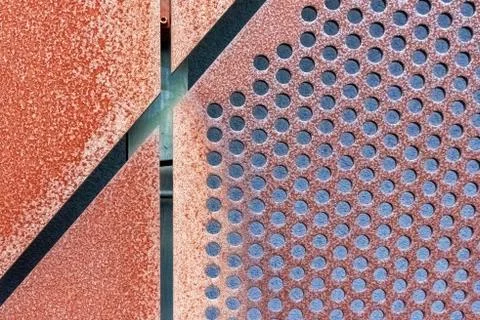 Abstract geometric background with rusty perforated metal cladding plates Stock Photos