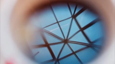 Abstract geometric ceiling pattern with blue sky reflection in a building, .. Stock Footage 339378317
