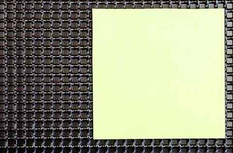 An abstract geometric composition of black repeating squares and a sheet of p Stock Photos