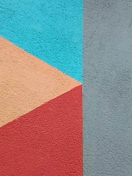 Abstract geometric painted plaster wall surface showing multiple bright colors Stock Photos