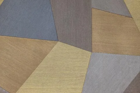 Abstract geometric patchwork fabric background with blue, brown, gold and grey Stock Photos