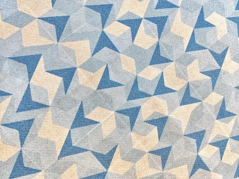 Abstract geometric pattern features intersecting blue and beige triangles on  Foto stock