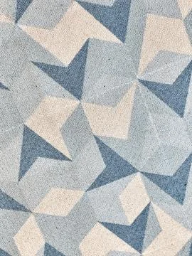 Abstract geometric pattern featuring beige, light blue and navy blue angular  Foto stock