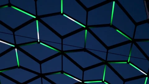 Abstract geometric pattern of glowing green neon lights in a hexagonal grid.. Stock Footage 345615764
