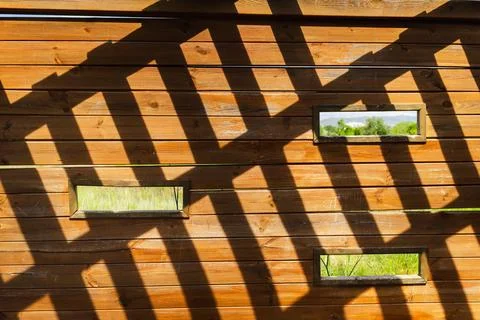 Abstract geometric shadow pattern inside wooden birdwatching hide, featuring Stock Photos