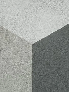 Abstract geometric wall corner with light and dark gray textured concrete Stock Photos