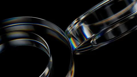 Abstract glass rings intertwining, creating iridescent light patterns on a .. Stock Photos