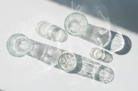 Abstract glassware shadows background. Reflections at natural light. Stock Photos