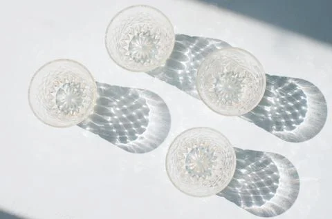 Abstract glassware shadows background. Reflections at natural light. Stock Photos