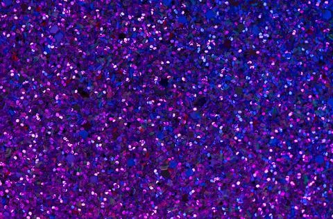 Abstract glitter background with blue-violet neon illumination. Stock-Fotos