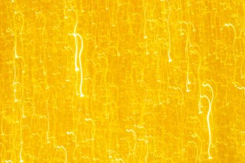 Abstract glitter golden glowing sparkling shiny background. Holiday gold wrap Stock Photos