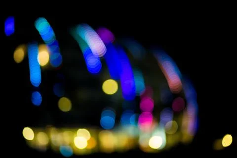 Abstract glowing background. Defocused multi-colored lights of a large buildi Stock Photos