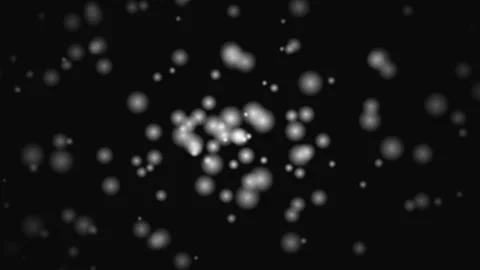 Abstract glowing bokeh particles floating in darkness 動画素材 345975667