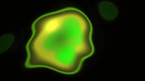 Abstract glowing cell nucleus pulsating with green light on black background. Stock Footage 334465337