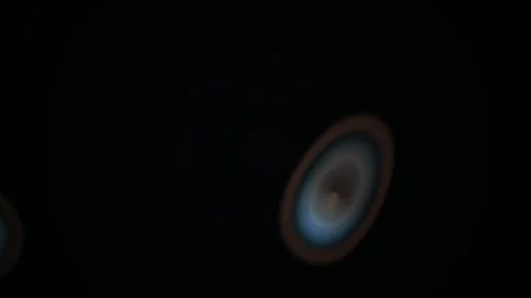 Abstract glowing circular lens flare light leaks effect on black background. Stock Footage 346329605
